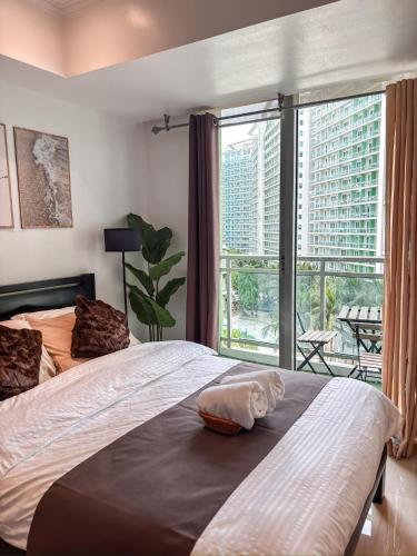 a bedroom with a large bed and a large window at Casa Del Sol in Manila