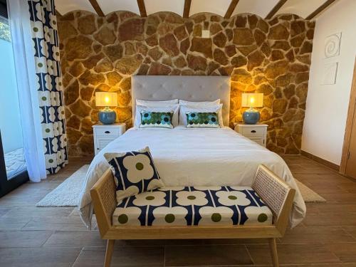 a bedroom with a large bed with two lamps at Casa de Olivos - Unique Apartments - Adult Only in Traiguera