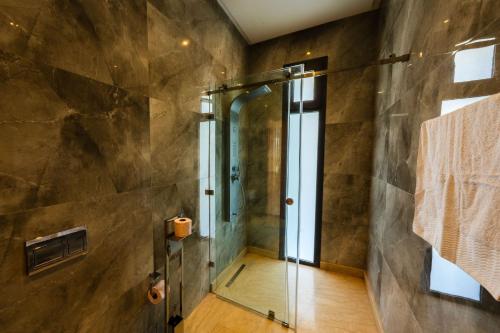 a bathroom with a shower with a glass door at Villa Dar E'Zwinna in Marrakesh