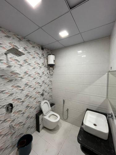 a bathroom with a toilet and a sink at hotel rajwada in Bhuj
