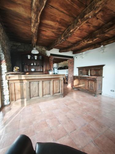 a large kitchen with wooden cabinets and a tile floor at Country Cottage by LePigne World in Ameno
