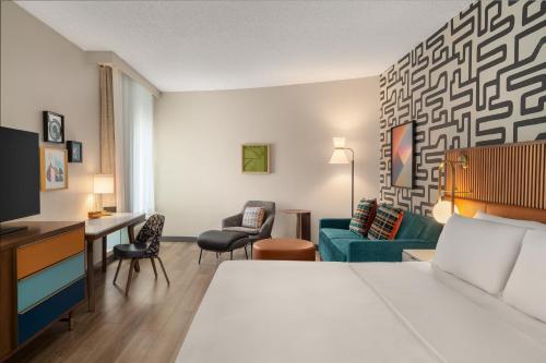 a hotel room with a bed and a desk at Hotel Indigo Columbus Architectural Center by IHG in Columbus