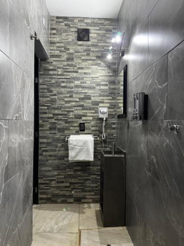 a bathroom with a sink and a brick wall at Loft en tequila Jalisco in Tequila