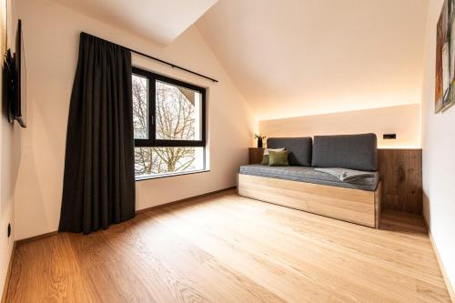 a bedroom with a bed and a window at Senner Nature Stay in Riscone