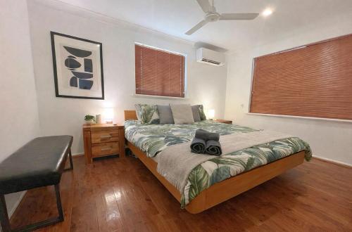 a bedroom with a bed and a desk and window at Humble & Homely in Rockingham