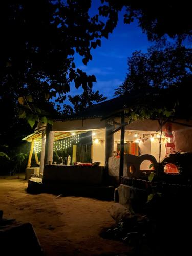 a house lit up at night with lights at Bush Baby Compound in Gunjur