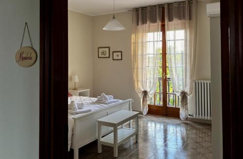 a bedroom with a bed and a chair and a window at Terrarossa in Crispiano