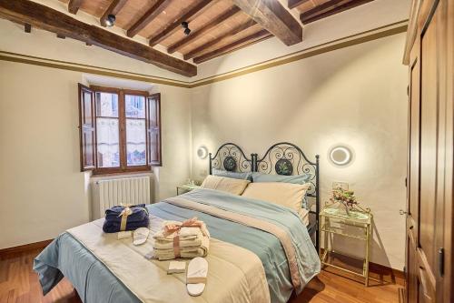 a bedroom with a bed with two bags on it at Vicolo Nobile in Montepulciano
