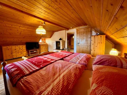 a bedroom with a bed in a wooden room at Die Petzl Hütte - Kreischbergblick in Kaindorf
