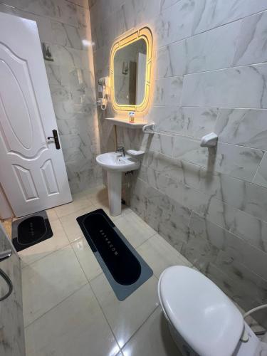 a bathroom with a toilet and a sink and a mirror at Royal hotel Tanta - فندق رويال طنطا in Tanta