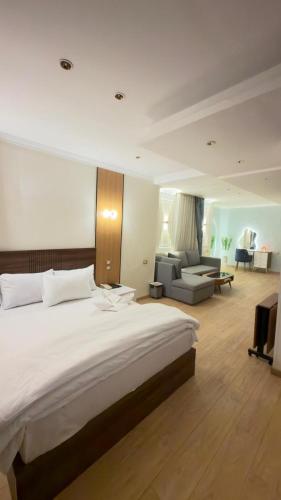 a bedroom with a large bed and a living room at Royal hotel Tanta - فندق رويال طنطا in Tanta