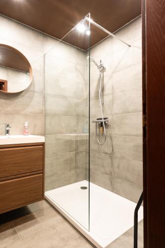 a shower with a glass door in a bathroom at Haus Waldruhe in Mallnitz