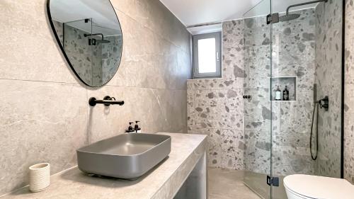 a bathroom with a sink and a mirror at Eleonas Limeni in Limeni