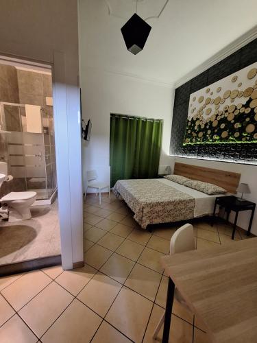 a bedroom with a bed and a green curtain at Fontanarossa Airport Home in Catania