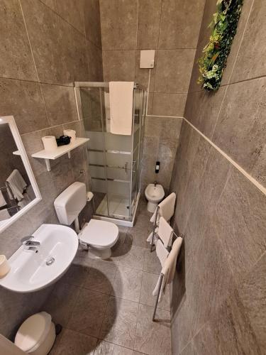 a bathroom with two toilets and a sink at Fontanarossa Airport Home in Catania