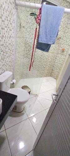 a bathroom with a toilet and a towel at Casa inigualavel in Caucaia