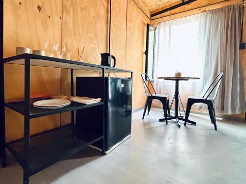 a living room with a table and chairs and a shelf at Alamos in Puerto Madryn