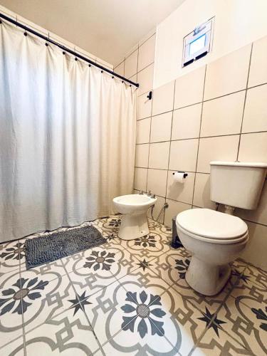 a bathroom with a toilet and a sink at Alamos in Puerto Madryn