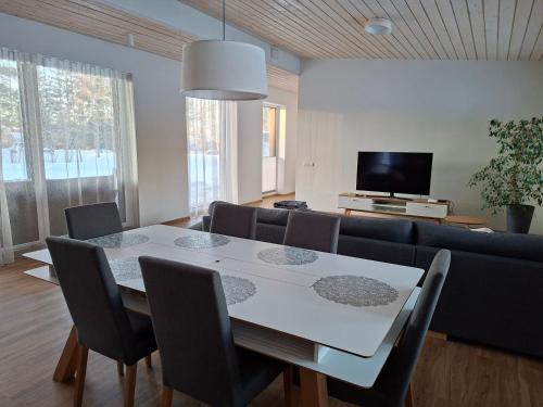 a living room with a table and a couch at Puhkemaja Pühajärvel in Otepää