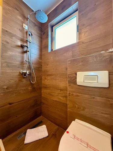 a bathroom with a toilet and a window and a shower at Hotel Previla in Sarajevo