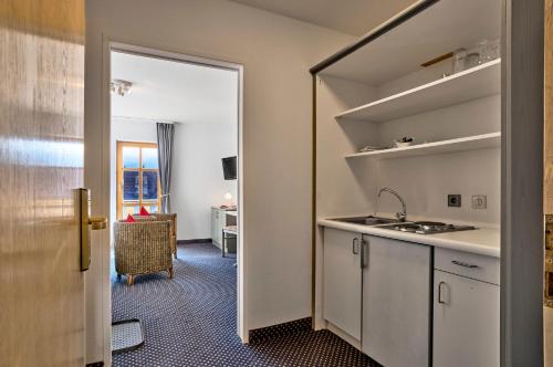a kitchen with a sink and a counter top at Das Arber-Hotel am Rothbach in Bodenmais