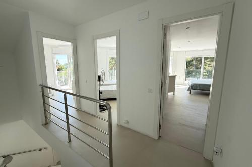 a white room with a staircase leading to a bedroom at Casablanca-Private Family Mountain Home in El Amunt