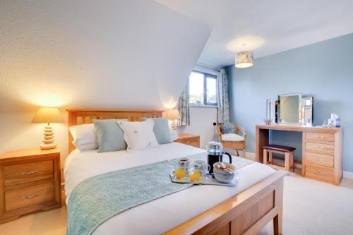 a bedroom with a bed with a tray of food on it at 3 Bed in Cromer oc-2097 in Cromer