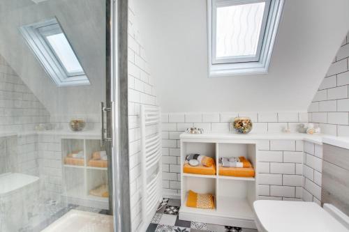 a white bathroom with a shower and a toilet at 3 Bed in Cromer oc-2097 in Cromer