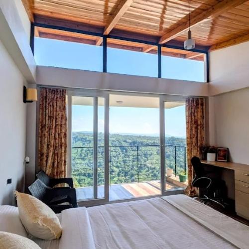 a bedroom with a bed and a large window at Stay At Cottages in Pynursla
