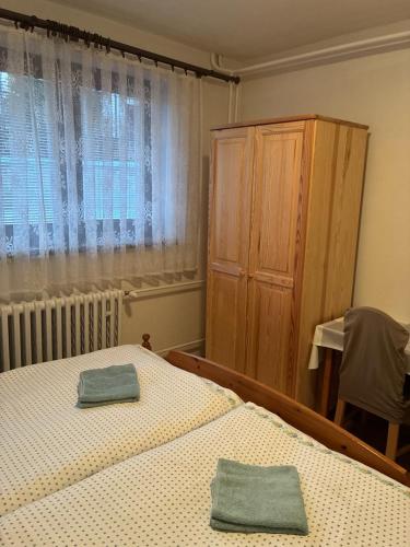 a bedroom with a bed with two towels on it at Privat u Frey in Nová Lesná