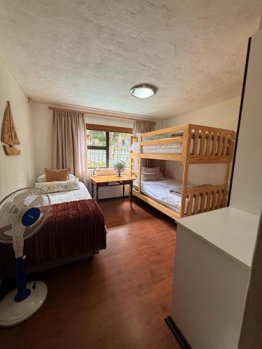 a bedroom with two bunk beds and a window at Hetta's@Delmar in Jeffreys Bay