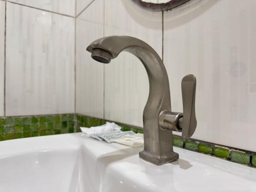 a faucet on a white sink in a bathroom at Ruen Thong Resort in Phang-nga