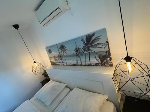 a bedroom with a bed and a picture of palm trees at Casa Bep in Zevenhuizen
