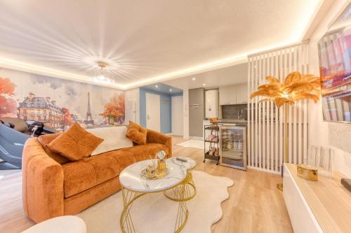 a living room with a couch and a table at Premium Spa Suite Jacuzzi Hot Tub Massage Chair near Paris Eiffel Tower-Stade de France-CDG Airport in Drancy