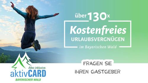 a woman jumping in the air with the words fender kostefets at Haus im Grünen l Hot Tub l aktivCARD inklusive in Regen
