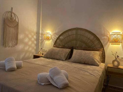 a bedroom with a large bed with towels on it at DM Seaside House in Perissa