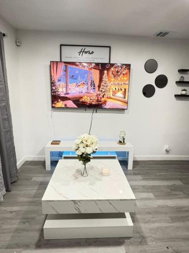 a room with a table with a vase of flowers at Family Home WITH 3 BR & 1RR in Grand Prairie