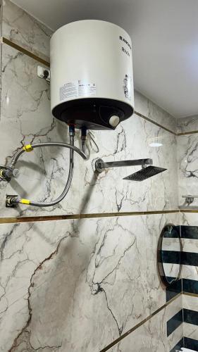 a light on a wall in a bathroom at Hotel Monsoon in Warangal