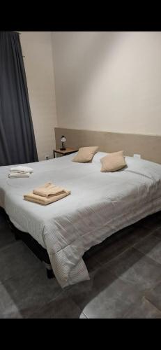 a large bed with towels on top of it at Umbrella4 in La Rioja