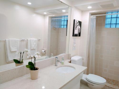 a white bathroom with a sink and a toilet at U of A Homestay, Trails & Whyte Ave in Edmonton