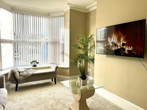 a living room with a fire place on the wall at Stylish home from home in Nether Edge