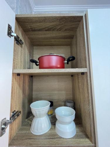 a cabinet with a pot and two toilets in it at VERO Residence in Hurghada