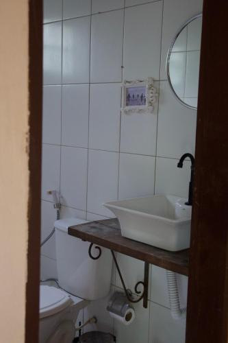 a bathroom with a sink and a toilet at Casa Kahlo in Lençóis