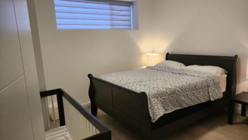 a bedroom with a bed with a window and a bed sidx sidx sidx at Winnipeg Airport & Polo Park Suites in Winnipeg