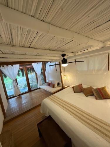 a bedroom with a large bed in a room at Refugio Alana Máncora in Máncora