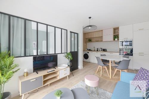 ein Wohnzimmer mit einem Tisch und ein Esszimmer in der Unterkunft Le Mirabeau in Rennes