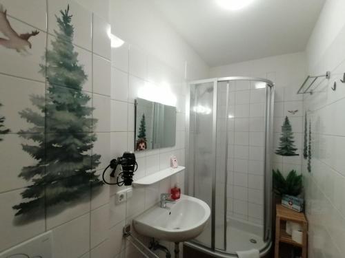 a bathroom with a christmas tree on the wall at Studio Steinbocks Chill in Kaprun