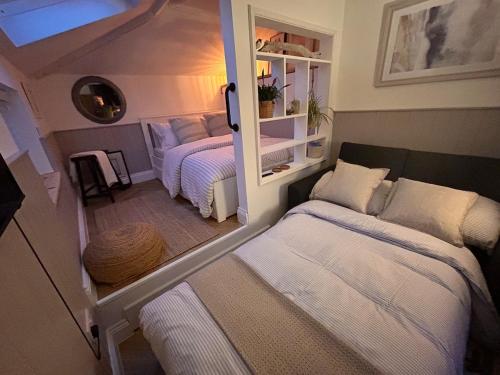 a small bedroom with two beds in a room at The Snug, Minehead in Minehead