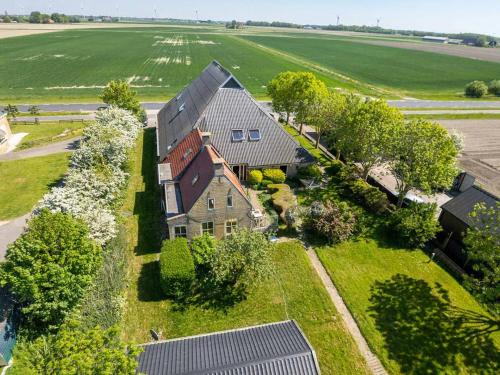 an aerial view of a large house with a yard at Pension Veldzigt in Wijnaldum