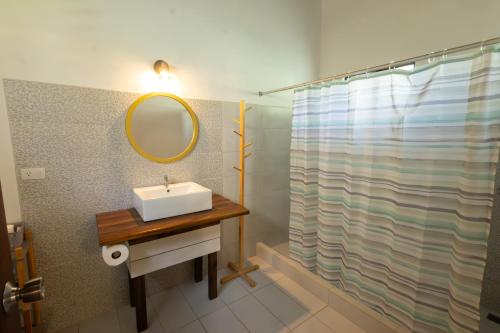 a bathroom with a sink and a mirror at Tortuga HBH in Playa Hermosa